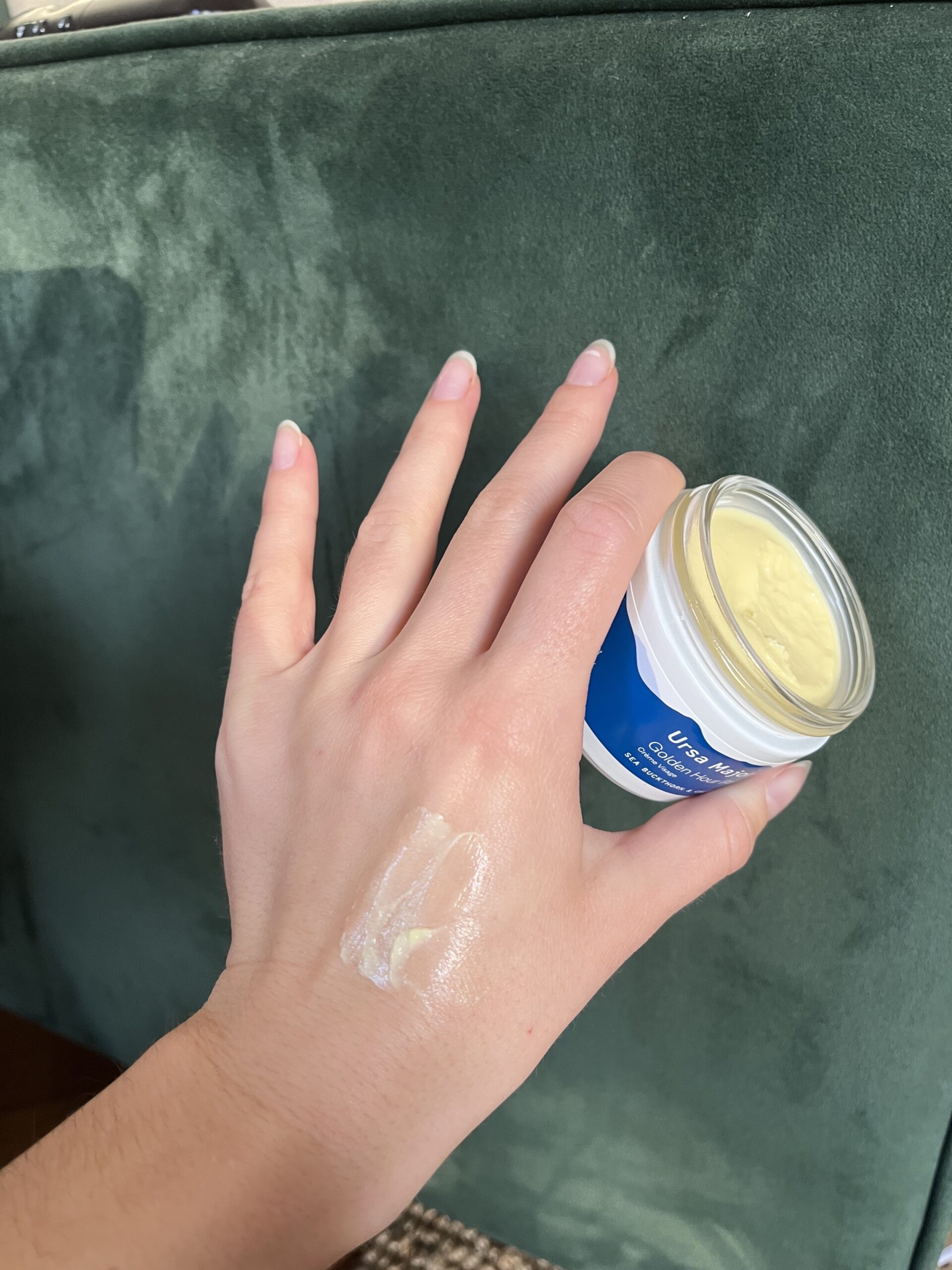 A hand holding Ursa Major cream