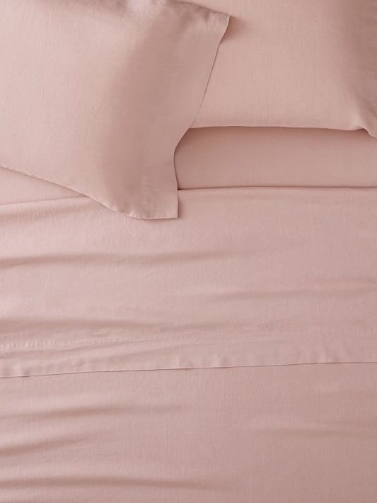 Rose-colored linen sheets.